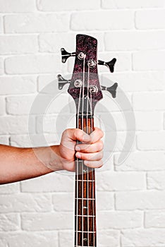 Hand holding a guitar neck