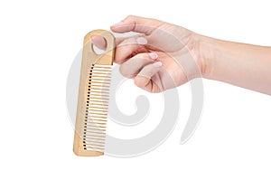 Hand holding hair brush isolated on white background