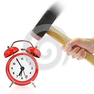 Hand holding hammer and red alarm clock