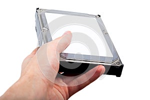 Hand holding and handing out a silver 3.5 inch HDD drive with an empty white blank sticker, label template, copy space. Hard drive