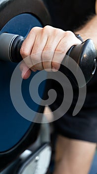 Hand holding handlebar to exercise