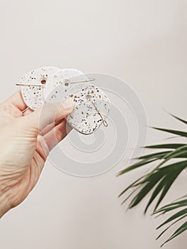 Hand holding handmade terrazzo christmas balls