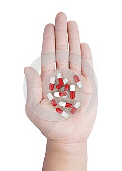 Hand holding heap of capsule pill