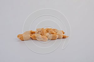 heap of salt roasted peanuts on white background