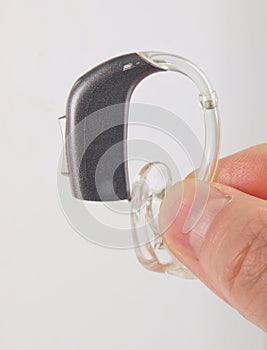 Hand holding hearing aid