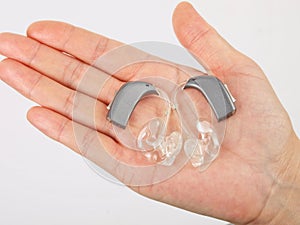 Hand holding hearing aid