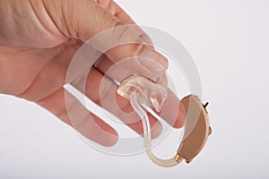 Hand holding a hearing aid