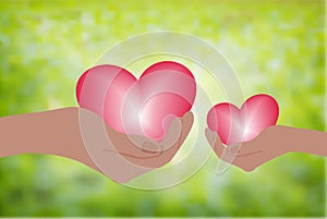 Hand holding heart.Give a pink heart with love.blurred green background