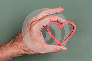 Hand holding a heart shape