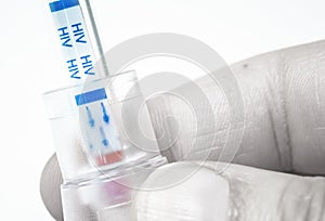 Hand holding HIV self-test with blood inside