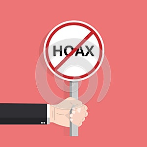 Hand holding hoax word typography sign design illustration. Fight symbol against lies, propaganda and fake news