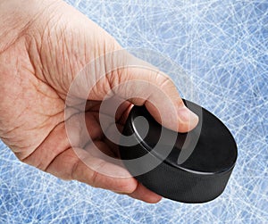 Hand holding a hockey puck