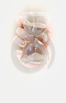 hand holding hourglass on empty space