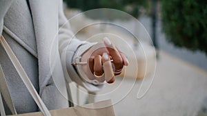 Hand holding house keys outside closeup. Real estate agent waiting rent client