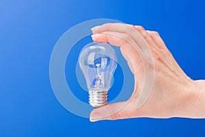 Hand holding a incandescent light bulb