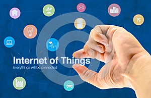 Hand holding Internet of things (IoT) word and object icon and b