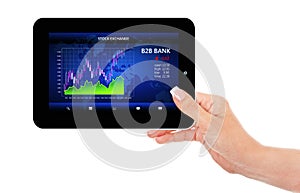 Hand holding ipad with stock market chart