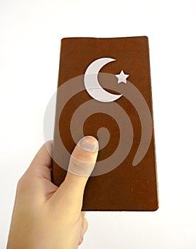 Hand Holding Islamic Book photo