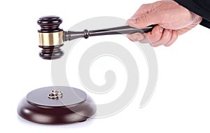 Hand holding a judge gavel above wedding rings