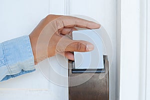 Hand Holding Key Card for Unlocking Door