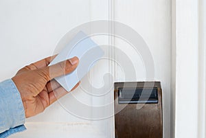 Hand Holding Key Card for Unlocking Door