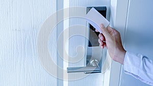 Hand holding key card using electronic card for access hotel room