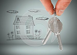 Hand Holding key with house drawing in front of vignette