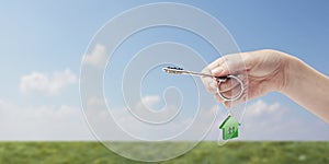 Hand holding key with a keychain