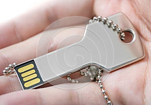 Hand holding a key shaped USB drive