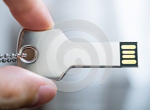 Hand holding a key shaped USB drive