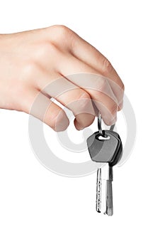 Hand holding keys to apartment on white background.
