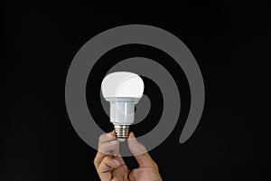 Hand holding LED light bulb