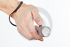 Hand holding a led torchlight on white background photo