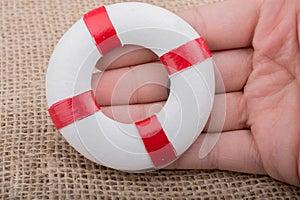 Hand holding a Lifesaver on fabric