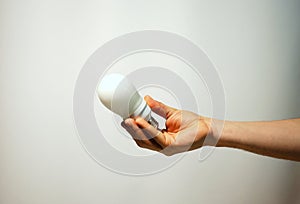 Hand holding light bulb