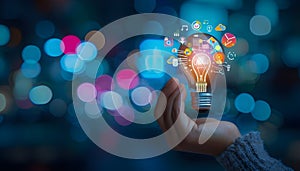 Hand holding light bulb and business digital marketing innovation technology