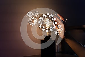 Hand holding light bulb and cog inside. Idea and imagination. Creative and inspiration. Innovation gears icon with network