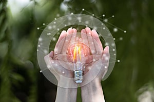 Hand holding light bulb, concept of new ideas with innovation and creativity