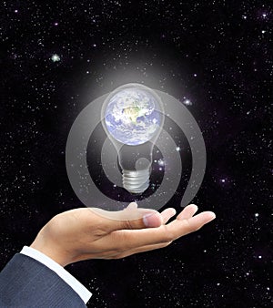 Hand holding light bulb earth (Earth view image fr