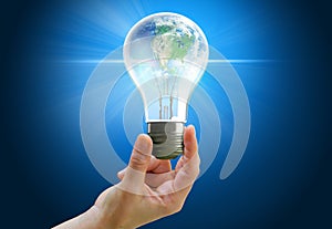 Hand holding light bulb globe