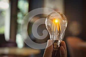 A hand holding is light bulb for save energy. Creative ideas concept, lightbulb for new idea