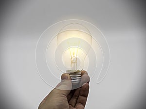 Hand holding light bulbs with glowing on nature background. Idea, creativity and saving energy with light bulbs concept