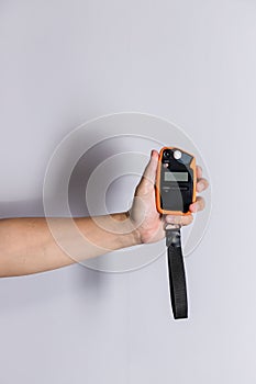 Hand holding light exposure meter, a photograph device for measuring illumination on white background. Hand held light meter isola