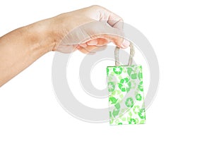 Hand holding little packet green recycle paper bag, isolated on white background