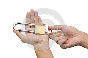 Hand holding, locking and unlocking brass padlock isolated