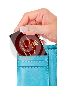 Hand holding loyalty card in wallet isolated over white