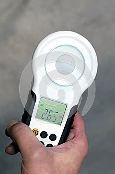 Hand holding lux meter. photo