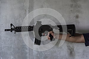 Hand holding M16 gun photo