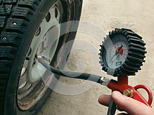 Hand holding machine Inflated pressure gauge for car tyre pressure measurement for automobile wheels. Air compressor gun with