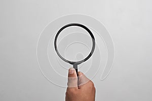 Hand holding Magnifying Glass